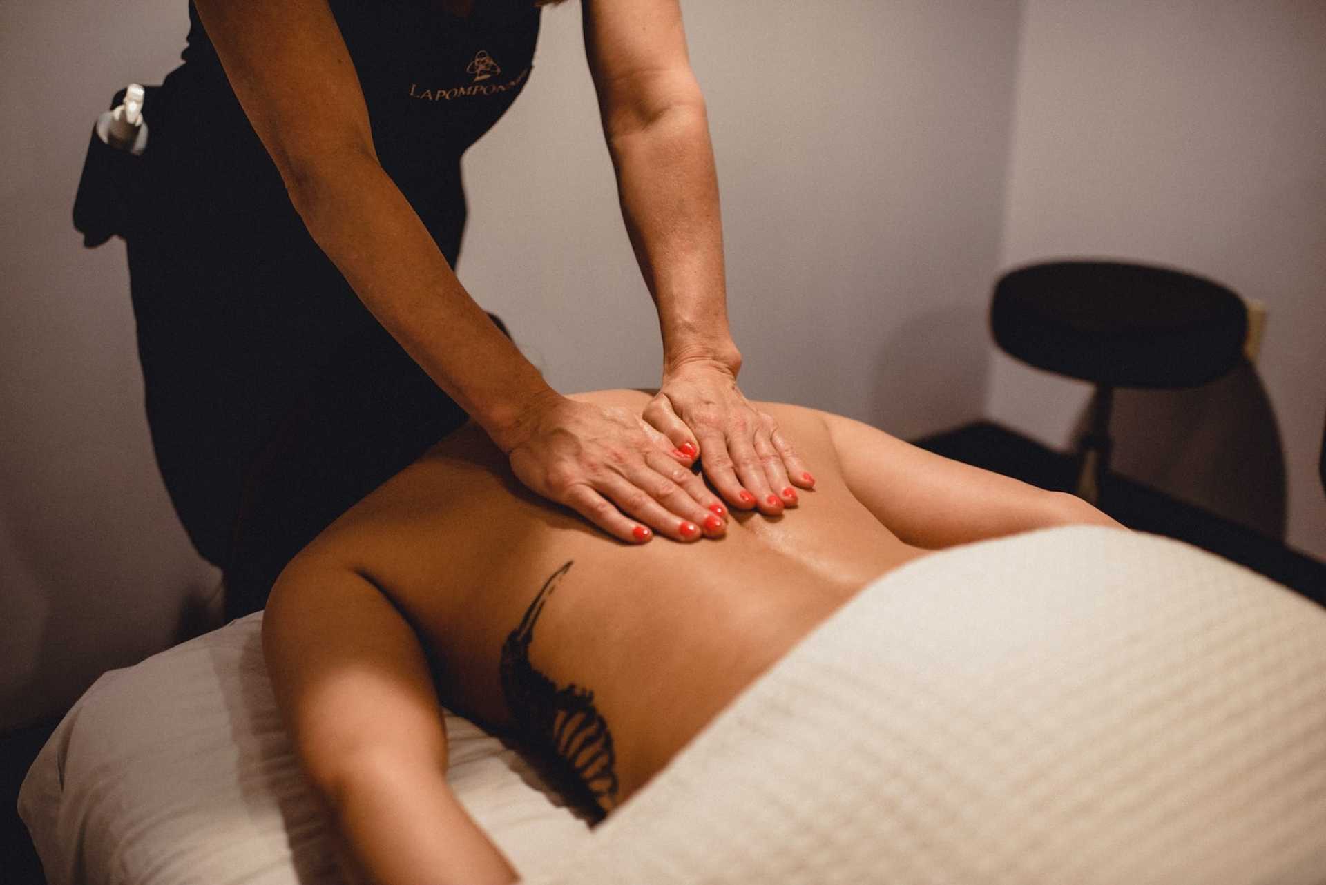 Person receiving a relaxing back massage in a spa setting.