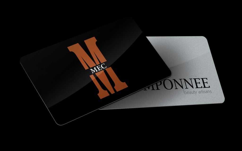 Two sleek business cards, one with a bold "MEC" logo, the other with "EMPONNEE" text.